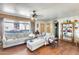 Cozy living room with hard wood floors, a ceiling fan, and a large window at 5501 E Dallas St, Mesa, AZ 85205