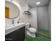 Clean bathroom with walk-in shower, updated vanity, and green mosaic tile at 5820 N 83Rd St, Scottsdale, AZ 85250
