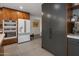 Modern kitchen with stainless steel appliances and wood cabinetry at 5820 N 83Rd St, Scottsdale, AZ 85250