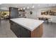 Modern kitchen with a large island, dark cabinetry, and quartz countertops at 5820 N 83Rd St, Scottsdale, AZ 85250
