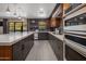 Spacious kitchen featuring dark cabinetry, quartz countertops, and a large island at 5820 N 83Rd St, Scottsdale, AZ 85250