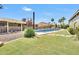 Inviting backyard oasis featuring a sparkling pool and grassy lawn at 5820 N 83Rd St, Scottsdale, AZ 85250