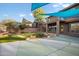 Backyard view from the house showing putting green and patio, shaded by multiple sunshades at 6102 E Sonoran Trl, Scottsdale, AZ 85266