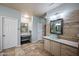 Bright bathroom featuring a vanity with a vessel sink and stylish tile floors and walls at 6102 E Sonoran Trl, Scottsdale, AZ 85266