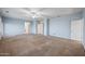 Large bedroom boasts a ceiling fan, neutral paint and carpet, and multiple entry points at 6102 E Sonoran Trl, Scottsdale, AZ 85266