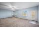 Spacious bedroom features a ceiling fan, neutral paint, and an exterior patio door at 6102 E Sonoran Trl, Scottsdale, AZ 85266
