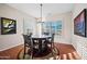 Cozy dining room with a round table, elegant chairs, and plantation shutters at 6102 E Sonoran Trl, Scottsdale, AZ 85266