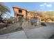 Beautiful home featuring desert landscaping, a walkway, and a spacious front yard at 6102 E Sonoran Trl, Scottsdale, AZ 85266