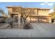 Inviting two-story home featuring a three-car garage and desert landscaping at 6102 E Sonoran Trl, Scottsdale, AZ 85266