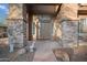 Elegant entryway with stone accents and a charming decorative goose statue at 6102 E Sonoran Trl, Scottsdale, AZ 85266