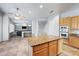 Open kitchen area with granite island and stainless double oven is conveniently placed next to the living area at 6102 E Sonoran Trl, Scottsdale, AZ 85266
