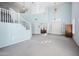 Bright living area with high ceilings, a staircase, and an open doorway to an office at 6102 E Sonoran Trl, Scottsdale, AZ 85266