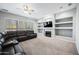 Comfortable living room features a fireplace, built-in shelves and a large TV at 6102 E Sonoran Trl, Scottsdale, AZ 85266