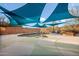 Backyard featuring a private pool, shaded by multiple blue sunshades at 6102 E Sonoran Trl, Scottsdale, AZ 85266