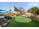 A green putting green in a backyard with desert landscaping at 6102 E Sonoran Trl, Scottsdale, AZ 85266