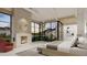 Main bedroom with fireplace, large windows, and private backyard access at 6109 E Maverick Rd, Paradise Valley, AZ 85253