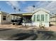 Single-wide manufactured home with carport and landscaped yard at 7750 E Broadway Rd # 677, Mesa, AZ 85208