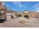 Private backyard features a covered patio, easy-care desert landscaping, and block wall for added seclusion at 7950 E Lakeview Ave, Mesa, AZ 85209