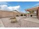 Spacious backyard with covered patio, rock landscaping, and mature trees for a peaceful setting at 7950 E Lakeview Ave, Mesa, AZ 85209