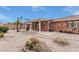 Landscaped backyard with covered patio, rock ground cover, and mature palm trees, creating a serene retreat at 7950 E Lakeview Ave, Mesa, AZ 85209