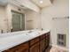 Bathroom featuring a vanity sink with a full mirror and shower with glass doors at 7950 E Lakeview Ave, Mesa, AZ 85209