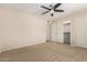 This carpeted bedroom features a ceiling fan and access to a walk-in closet at 7950 E Lakeview Ave, Mesa, AZ 85209