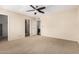 A spacious carpeted bedroom with an ensuite bathroom and walk in closet at 7950 E Lakeview Ave, Mesa, AZ 85209
