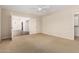 This bedroom features neutral carpet, ceiling fan, and doorway to an adjacent living space at 7950 E Lakeview Ave, Mesa, AZ 85209