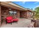 Cozy front porch with seating, potted plants, and a brick facade at 7950 E Lakeview Ave, Mesa, AZ 85209