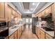 Well-appointed kitchen with stainless steel appliances, tiled backsplash, and natural wood cabinetry at 7950 E Lakeview Ave, Mesa, AZ 85209