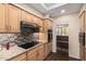 Kitchen featuring stone countertops, mosaic backsplash, light wood cabinetry, and stainless appliances at 7950 E Lakeview Ave, Mesa, AZ 85209