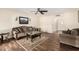 Comfortable living room featuring wood-look tile floors and modern ceiling fan at 7950 E Lakeview Ave, Mesa, AZ 85209