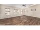 Inviting living room with wood-look tile floors, lots of natural light, and neutral wall color at 7950 E Lakeview Ave, Mesa, AZ 85209