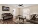 Comfortable living room featuring wood-look tile floors and modern ceiling fan at 7950 E Lakeview Ave, Mesa, AZ 85209