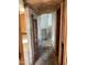 A narrow hallway with damaged walls and floors at 844 S Macdonald --, Mesa, AZ 85210