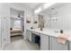 Elegant bathroom with double vanity, view to bedroom, and walk-in shower at 10037 E Rubidium Ave, Mesa, AZ 85212