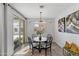 Bright dining room with a round table, four chairs, and backyard access at 10037 E Rubidium Ave, Mesa, AZ 85212