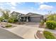 Gray craftsman style home with attached garage and well-manicured landscaping at 10037 E Rubidium Ave, Mesa, AZ 85212