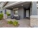 Charming front porch with stone columns and comfortable seating at 10037 E Rubidium Ave, Mesa, AZ 85212