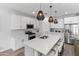 Modern kitchen with white cabinets and a large island at 10037 E Rubidium Ave, Mesa, AZ 85212