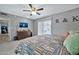 Main bedroom with dresser, ceiling fan, and sliding door to patio at 10312 W Sierra Dawn Dr, Sun City, AZ 85351