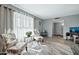 Spacious living area with two armchairs, a console table, and large windows at 10312 W Sierra Dawn Dr, Sun City, AZ 85351