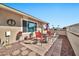 Small patio with red chairs and table, next to a rock wall and a flag at 10312 W Sierra Dawn Dr, Sun City, AZ 85351