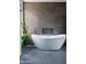 Bathroom with large, free-standing bathtub and grey tile at 10598 E Fernwood Ln, Scottsdale, AZ 85262