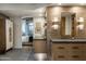 Bathroom with floating vanity, large mirror, and bedroom view at 10598 E Fernwood Ln, Scottsdale, AZ 85262