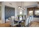 Elegant dining room features a rustic table and modern lighting at 10598 E Fernwood Ln, Scottsdale, AZ 85262