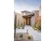 Modern entryway with stone accents and drought-tolerant plants at 10598 E Fernwood Ln, Scottsdale, AZ 85262