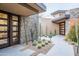 Elegant entryway with a stone wall and desert landscaping at 10598 E Fernwood Ln, Scottsdale, AZ 85262