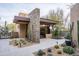 Modern home with stone accents and drought-tolerant landscaping at 10598 E Fernwood Ln, Scottsdale, AZ 85262