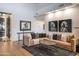 Relaxing living room features a large sectional sofa and wine cellar access at 10598 E Fernwood Ln, Scottsdale, AZ 85262